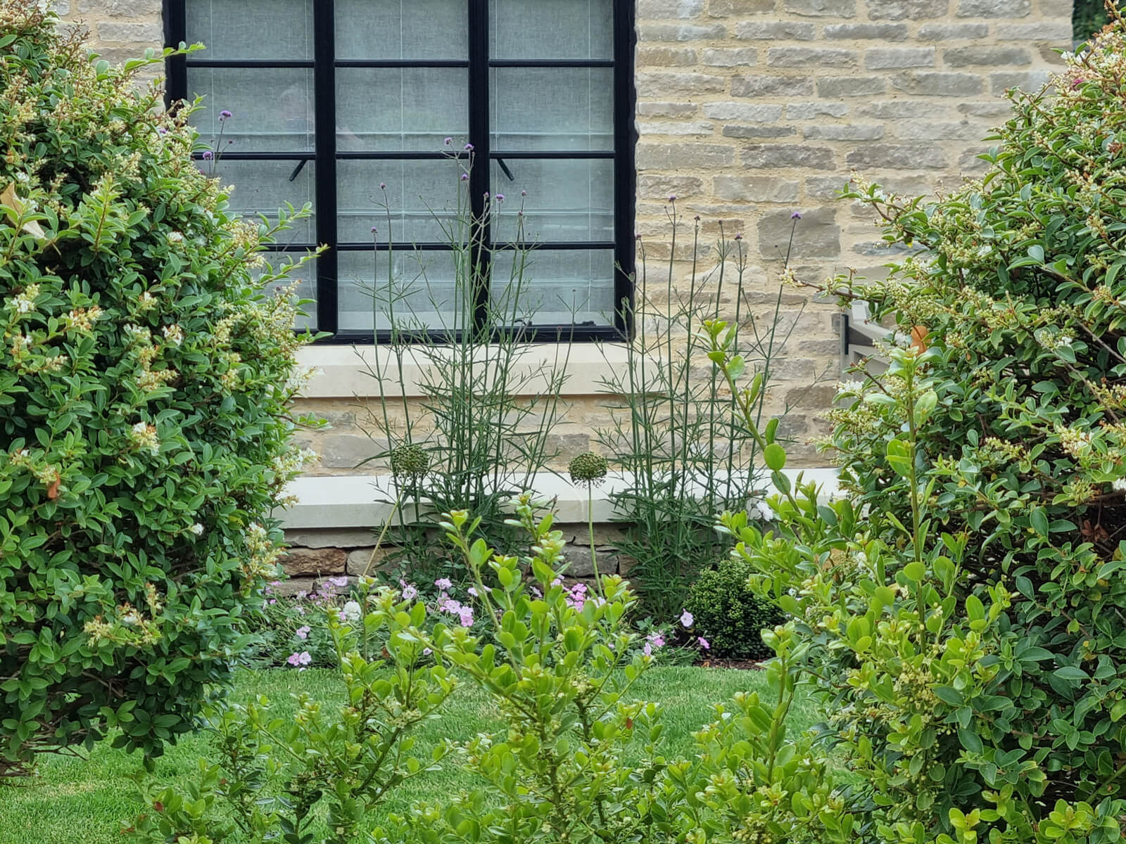 The Courtyard and Cottage Garden, a low maintenance mediterranean themed garden for a small country house. Designed by April House – Award Winning Cotswolds Garden Design