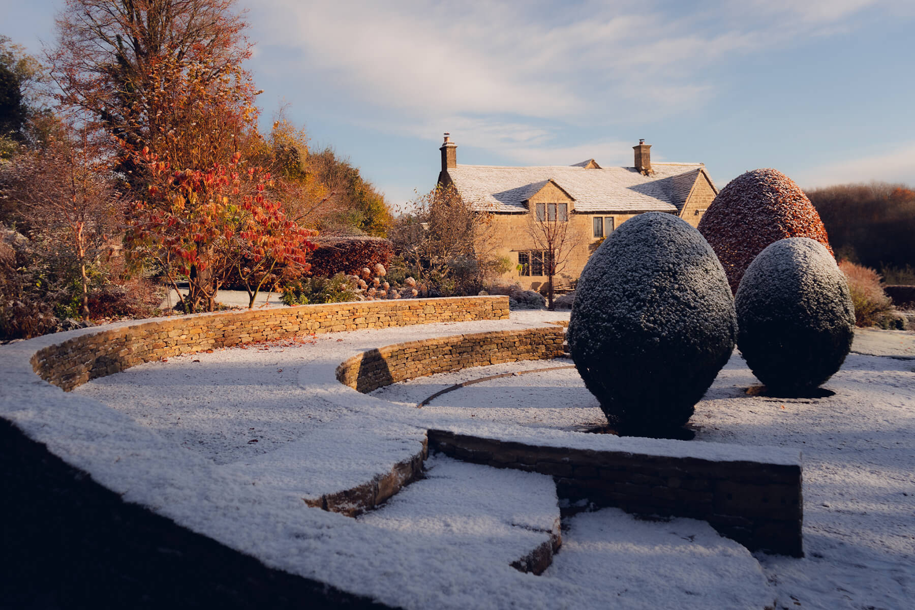 The Sunken Garden, an established cotswold garden with redesigned sunken garden surrounded by curved dry stone walls. Designed by April House – Award Winning Cotswolds Garden Design